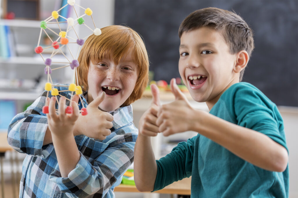 Excited boys complete fun engineering project at school